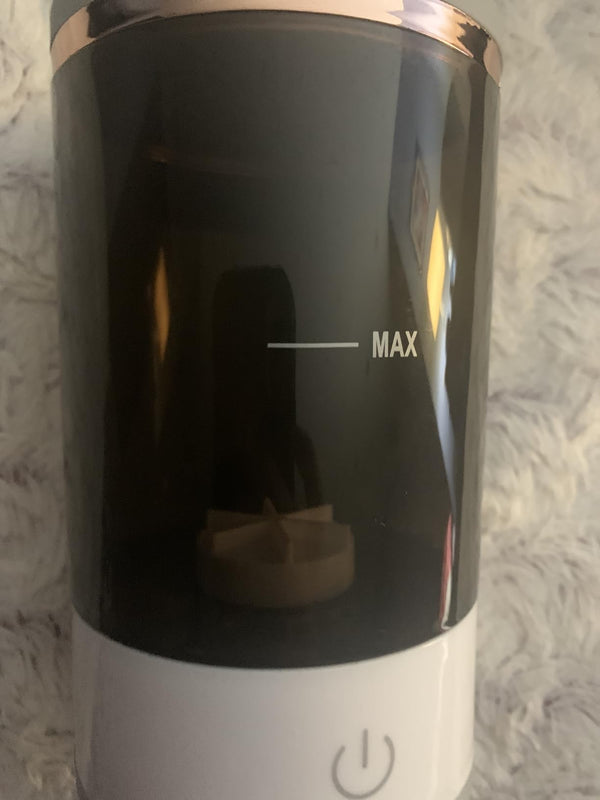 Black and white electronic device with 'MAX' indicator on a textured surface